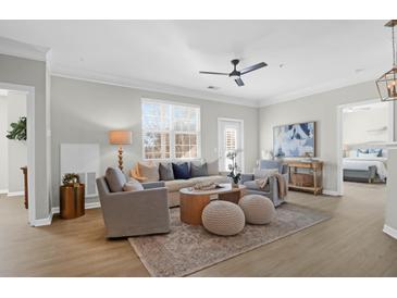 Inviting living room with stylish furniture, wood floors, and natural light at 1485 Cambridge Lakes Dr # 203, Mount Pleasant, SC 29464