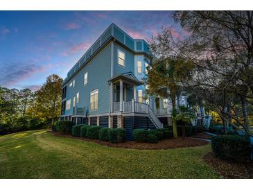 Charming coastal home exterior with front porch at twilight at 2032 Amenity Park Dr, Mount Pleasant, SC 29466