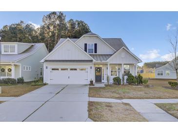 Two-story house with white siding, gray roof, and a two-car garage at 373 Whispering Breeze Ln, Summerville, SC 29486