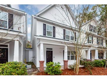 Two story home with white siding, dark shutters, and a front porch at 8194 S Antler Dr, North Charleston, SC 29406