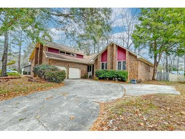 Brick house with attached garage and mature landscaping at 152 Hickory Trace Dr, Goose Creek, SC 29445