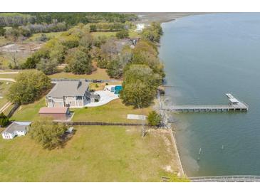 Aerial view of waterfront property with home, pool, dock, and expansive yard at 2432 Hanscombe Point Rd, Johns Island, SC 29455