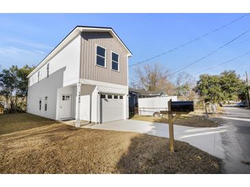 Two-story house with white and gray siding, attached garage, and small front yard at 1992 Groveland Ave, North Charleston, SC 29405