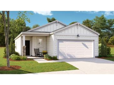 One-story home with white siding, a two-car garage, and a welcoming front porch at 304 Tiliwa Street, Summerville, SC 29486