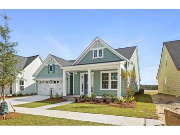 Quaint craftsman style home with light green siding and a welcoming front porch at 364 Trailmore Ln, Summerville, SC 29486