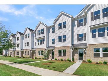 Row of townhouses, featuring white siding and landscaping at 5136 Double Eagle, Summerville, SC 29485