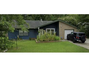 Ranch style home with blue siding, attached garage, and well-maintained lawn at 607 Mountain Pine Road, Moncks Corner, SC 29461
