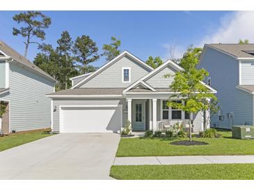 Gray-tone shingle house with white garage door and front porch at 130 Brant Dr, Summerville, SC 29483