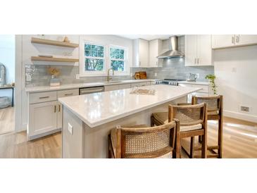 Modern kitchen with white cabinets, quartz countertops, and stainless steel appliances at 1349 Coosaw Dr, Charleston, SC 29407