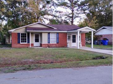 Brick ranch home with carport and landscaped lawn at 7660 Crossgate Blvd, North Charleston, SC 29420