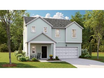 Two-story house with light green siding, a two-car garage, and a rocking chair front porch at 1002 Lovebug Ln, Summerville, SC 29485