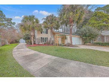 Beige two-story house with palm trees, a curved driveway and a detached shed at 212 Glenda View, Ladson, SC 29456