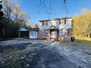 Brick home with carport and large yard at 144 Butterfly Ln, Moncks Corner, SC 29461