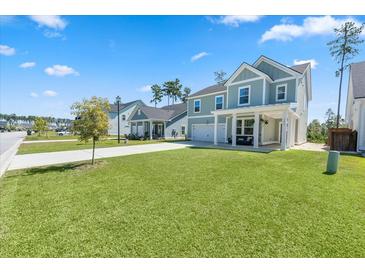 Two-story home with front porch and landscaped lawn at 153 Belfort Pl, Summerville, SC 29486