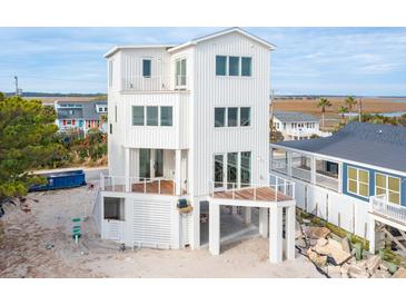 Elevated view of a three-story beach home with expansive decks at 1579 E Ashley Ave, Folly Beach, SC 29439