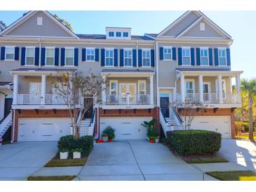 Three-story townhouses with navy shutters, brick accents, and two-car garages at 1899 Carolina Towne Ct, Mount Pleasant, SC 29464