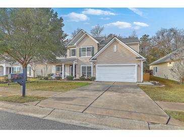 Two-story house with a beige exterior, a white garage door, and a well-maintained lawn at 240 Mayfield Dr, Goose Creek, SC 29445