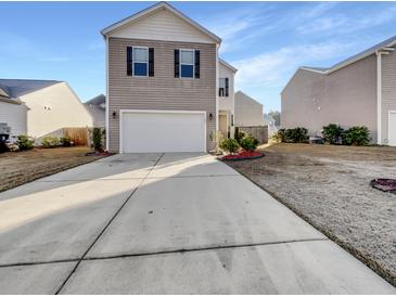 Two-story house with attached garage and landscaped yard at 140 Stoney Creek Way, Moncks Corner, SC 29461