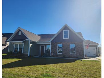 Two-story craftsman style home with stone accents and a landscaped lawn at 219 Darby Meadow Ln, Ridgeville, SC 29472
