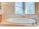 Spa-like bathroom with a corner soaking tub and tiled walls at 913 Carolina Blvd, Isle of Palms, SC 29451