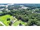 Aerial view of homes and properties surrounded by lush greenery at 1633 Rose Dr, Summerville, SC 29486