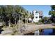 Lovely waterfront home with palm trees and a private driveway at 268 Little Oak Island Dr, Folly Beach, SC 29439