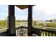 Balcony with wicker chairs and glass top table overlooking scenic water views at 268 Little Oak Island Dr, Folly Beach, SC 29439