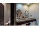 Double vanity bathroom with stone countertops and decorative mirrors at 268 Little Oak Island Dr, Folly Beach, SC 29439