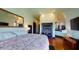 Main bedroom with fireplace, large TV, and hardwood floors at 268 Little Oak Island Dr, Folly Beach, SC 29439