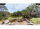 Spacious wooden deck overlooking a tranquil pond and lush greenery at 268 Little Oak Island Dr, Folly Beach, SC 29439