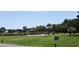 Community gazebo with picnic tables and fire pit near a pond at 268 Little Oak Island Dr, Folly Beach, SC 29439