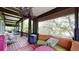 Relaxing screened porch with wooden floors, wicker furniture, and peaceful water views at 268 Little Oak Island Dr, Folly Beach, SC 29439