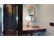 Elegant powder room with granite countertop and ornate mirror at 268 Little Oak Island Dr, Folly Beach, SC 29439