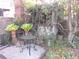 Small backyard with overgrown plants, a small table and a dilapidated structure at 5 President Pl, Charleston, SC 29403