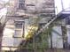 Run-down exterior with weathered wood siding and exposed staircase at 5 President Pl, Charleston, SC 29403
