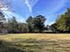 Wide open property with a farmhouse and outbuildings at 2043 Bohicket Rd, Johns Island, SC 29455