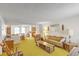 Living room, vintage furniture, yellow carpet, view to kitchen at 1447 Fort Lamar Rd, Charleston, SC 29412