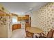 Kitchen with wood cabinets, appliances, and floral wallpaper at 1447 Fort Lamar Rd, Charleston, SC 29412