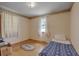 Small bedroom with wood floors, a twin bed, and a window with curtains at 1447 Fort Lamar Rd, Charleston, SC 29412