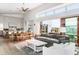 Open living space with gray sofa, wooden coffee table, and access to deck at 3115 Ion Ave # C, Sullivans Island, SC 29482
