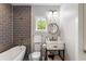 Modern bathroom with gray tile, freestanding bathtub, and a white vanity at 3115 Ion Ave # B, Sullivans Island, SC 29482