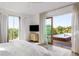 Bright bedroom with a king-size bed and sliding glass doors to a private deck and pool at 3115 Ion Ave # B, Sullivans Island, SC 29482