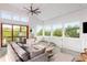 Bright living room with floor-to-ceiling windows and balcony access at 3115 Ion Ave # B, Sullivans Island, SC 29482