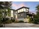 Modern coastal home with gray siding, large windows, and a two-car garage at 3115 Ion Ave # B, Sullivans Island, SC 29482