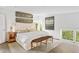 Bright bedroom with plush bed, wooden bench, and large window offering ample natural light at 3115 Ion Ave # B, Sullivans Island, SC 29482
