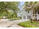Gray modern home with white garage doors and lush landscaping at 3115 Ion Ave # B, Sullivans Island, SC 29482