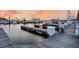Boats docked at a marina during a sunset with calm water at 1880 Andell Bluff Blvd # D-16, Seabrook Island, SC 29455