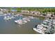 Aerial view of the marina, showcasing numerous boats and waterfront homes at 1880 Andell Bluff Blvd # D-16, Seabrook Island, SC 29455