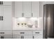 White kitchen with stainless steel appliances and quartz countertops at 516 Hayes Park Blvd # 1, Johns Island, SC 29455