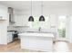 Spacious kitchen with white cabinets, quartz countertops and hardwood floors at 516 Hayes Park Blvd # 1, Johns Island, SC 29455